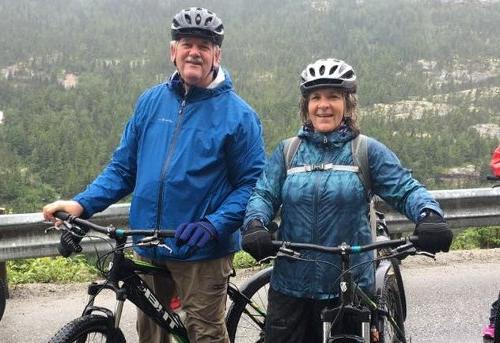 An image of Steve Collard and wife, Lydia, biking in Alaska.